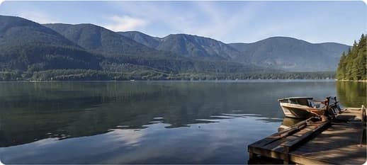 Morning view across Cultus Lake with mountains and a dock.
